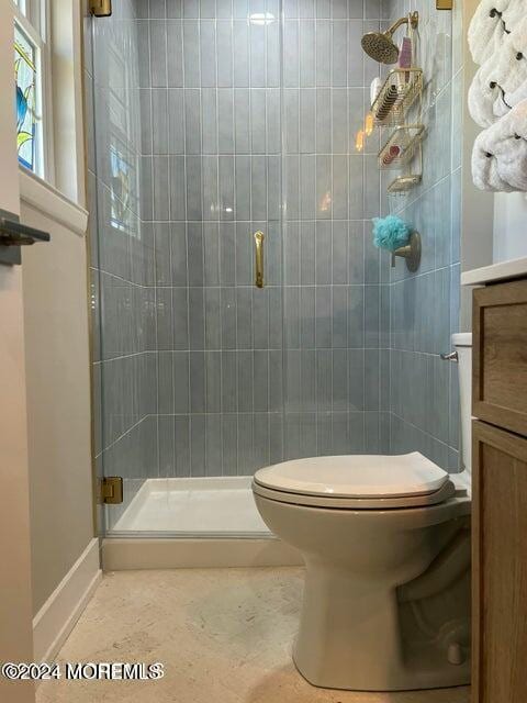 bathroom with toilet, vanity, and walk in shower