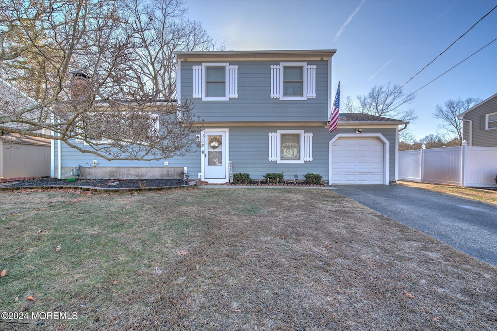 view of front property with a front lawn and a garage