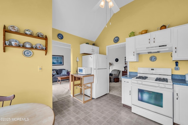 kitchen featuring white appliances, white cabinets, ceiling fan, high vaulted ceiling, and light colored carpet