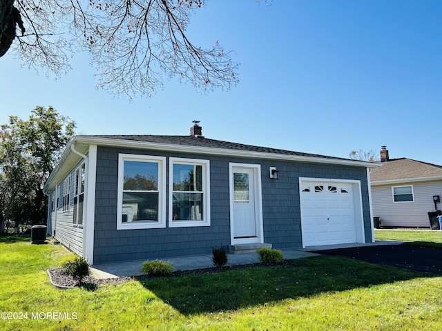 ranch-style house featuring central AC, a front lawn, and a garage