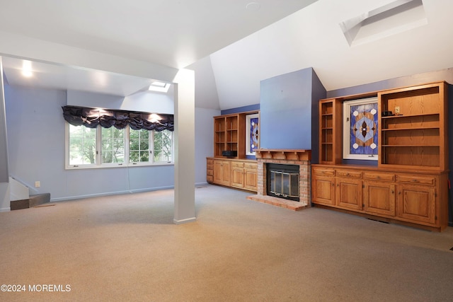 unfurnished living room with light colored carpet, lofted ceiling, and a brick fireplace