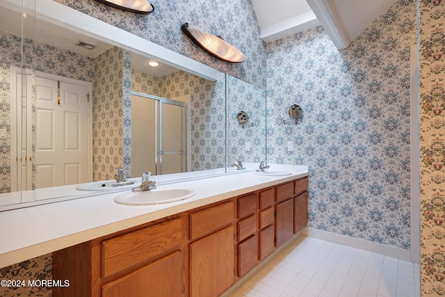 bathroom with tile patterned flooring, vanity, and a shower with shower door