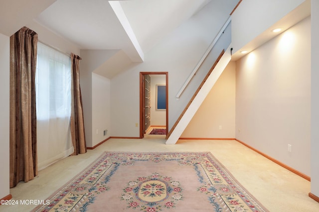 bonus room with light colored carpet