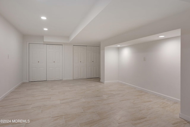 unfurnished bedroom with two closets