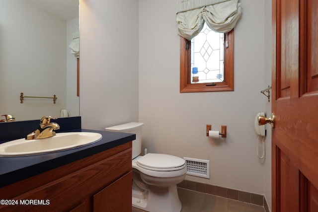 bathroom featuring tile patterned floors, vanity, and toilet