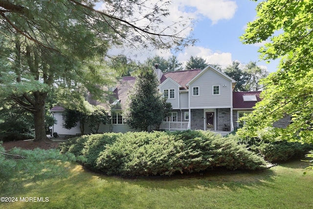 back of house with a lawn