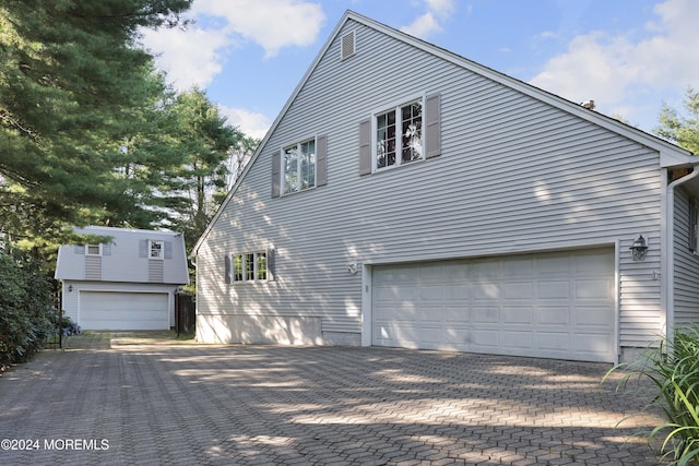 view of side of home featuring a garage