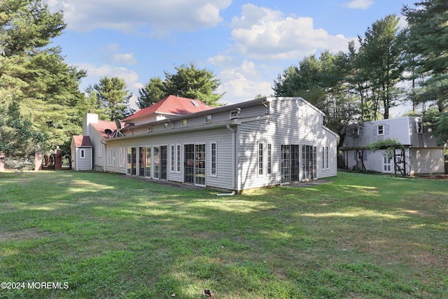 rear view of house with a lawn