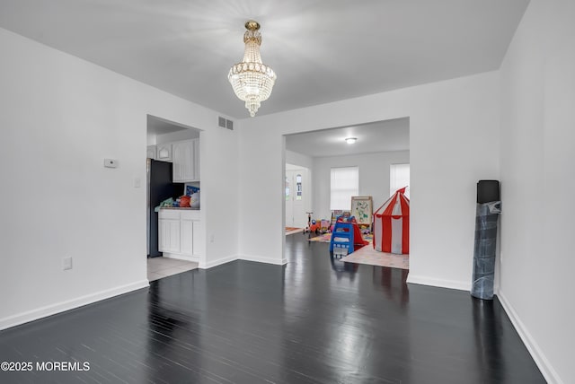 interior space with a chandelier and dark hardwood / wood-style floors