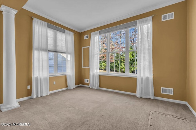 empty room with ornate columns, light carpet, and ornamental molding