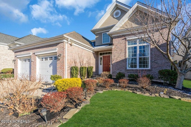 view of front property with a garage and a front yard