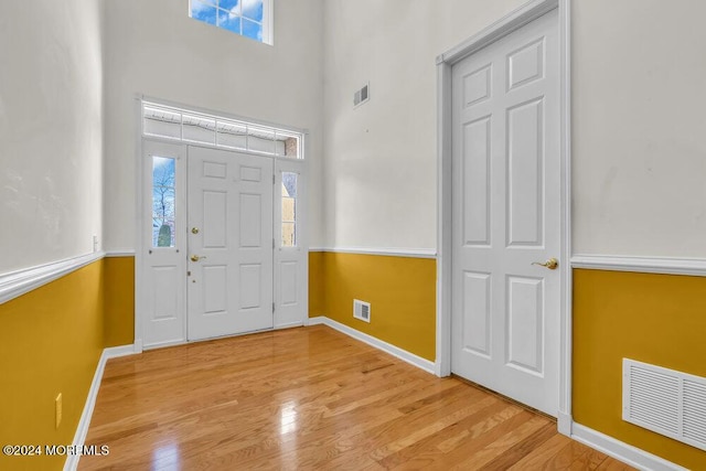 foyer featuring a high ceiling and light hardwood / wood-style floors