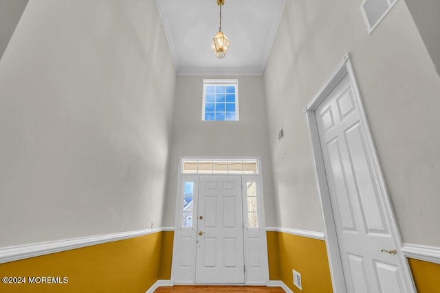 foyer featuring crown molding