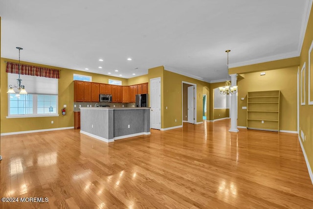 kitchen featuring a notable chandelier, decorative light fixtures, light hardwood / wood-style floors, and appliances with stainless steel finishes