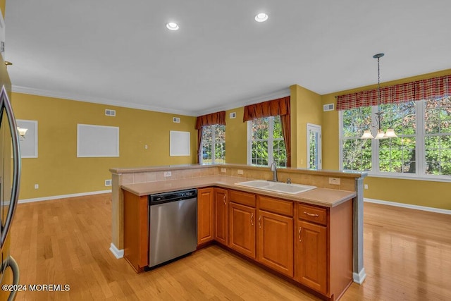 kitchen featuring sink, stainless steel dishwasher, a notable chandelier, decorative light fixtures, and light wood-type flooring