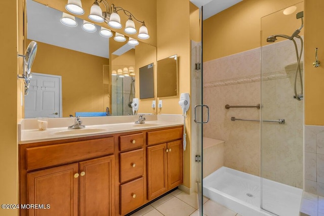 bathroom featuring tile patterned flooring, vanity, and walk in shower