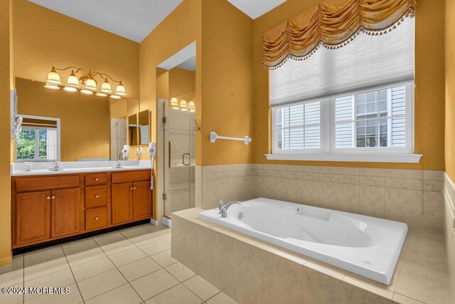 bathroom with plus walk in shower, vanity, and tile patterned floors