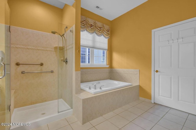 bathroom with tile patterned flooring and separate shower and tub