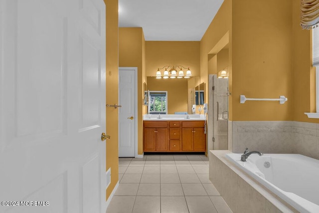 bathroom featuring vanity, tile patterned floors, and tiled tub