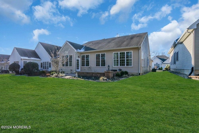 rear view of house with a yard