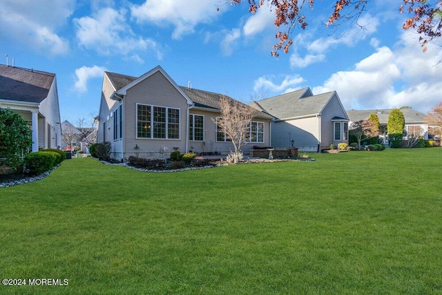 rear view of property with a yard