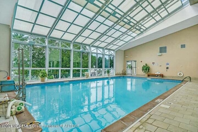 view of pool with a lanai and a patio