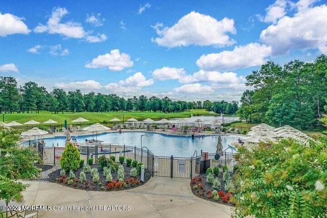 view of swimming pool featuring a water view