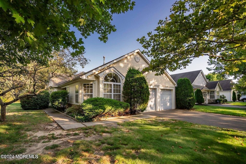 view of front of home with a front lawn and a garage