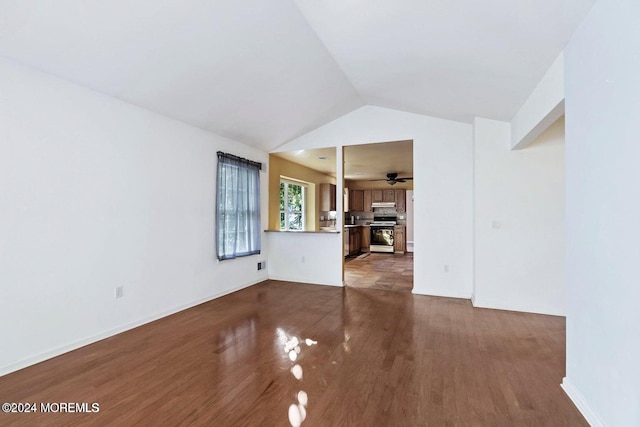 unfurnished living room with ceiling fan, dark wood-type flooring, and vaulted ceiling