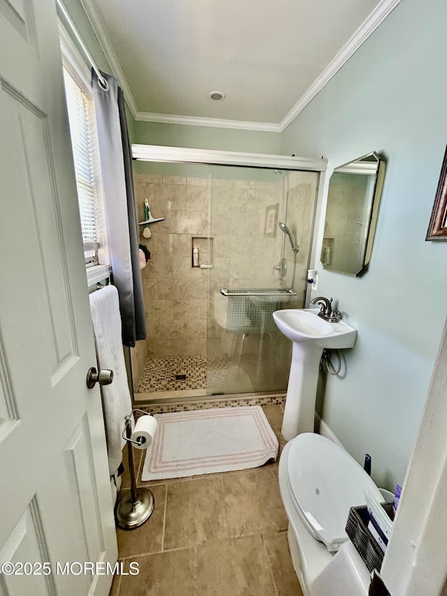 bathroom with a shower with shower door, tile patterned flooring, and crown molding