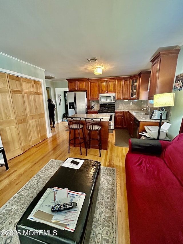 living room with sink and light hardwood / wood-style flooring