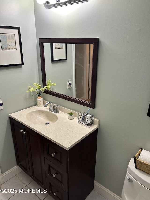 bathroom with toilet, tile patterned floors, and vanity