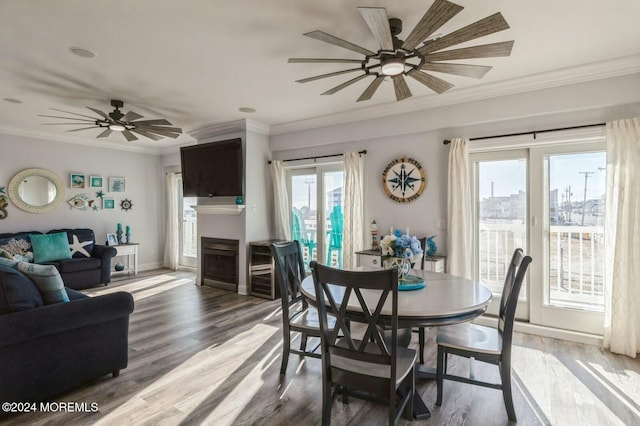 dining area featuring crown molding, plenty of natural light, ceiling fan, and hardwood / wood-style flooring