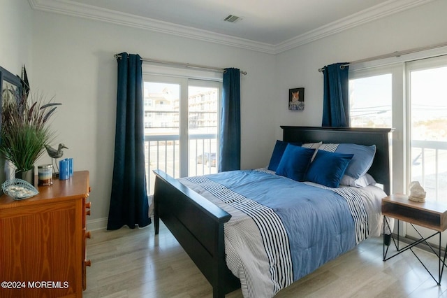 bedroom featuring ornamental molding and light hardwood / wood-style flooring