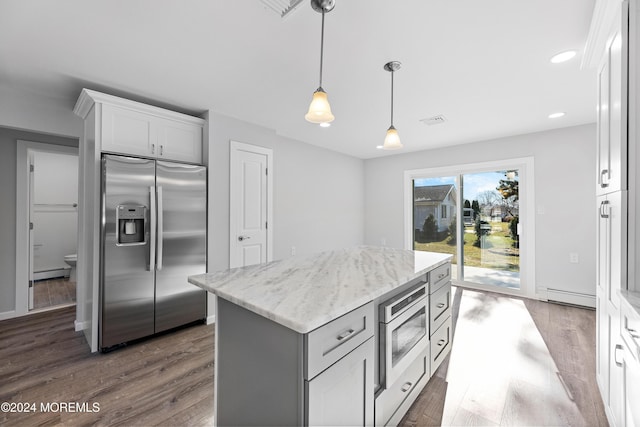 kitchen with pendant lighting, stainless steel refrigerator with ice dispenser, a baseboard radiator, a kitchen island, and white cabinetry