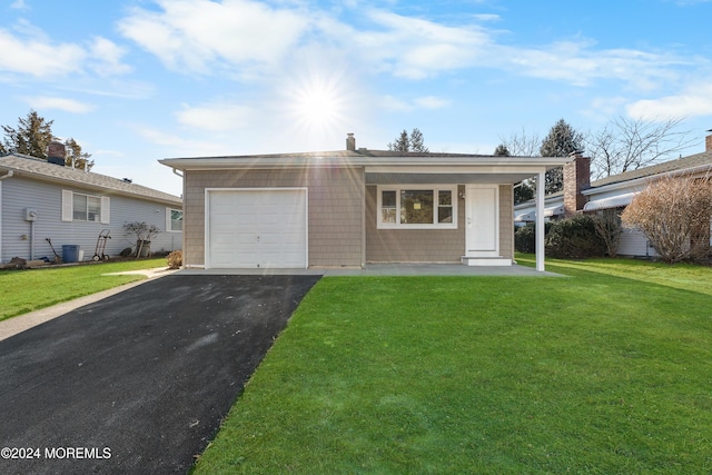 single story home featuring a garage and a front lawn