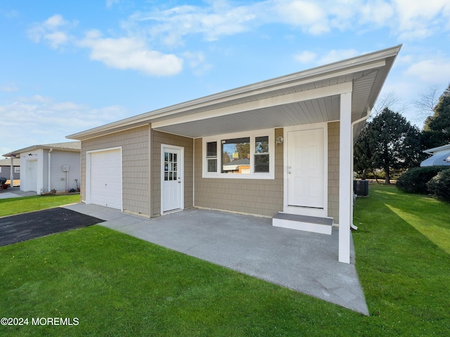 ranch-style home with cooling unit, a front lawn, a porch, and a garage