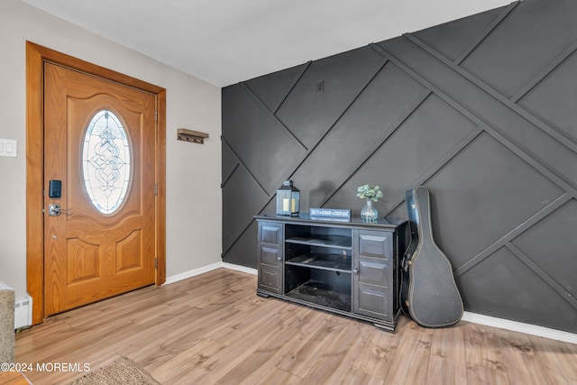 foyer with light hardwood / wood-style flooring and baseboard heating