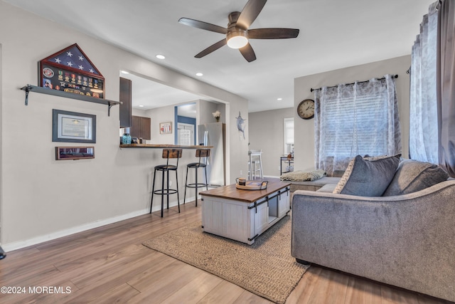 living room with ceiling fan and hardwood / wood-style floors