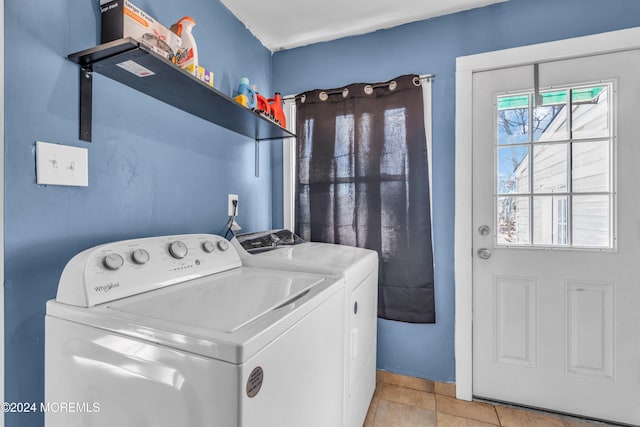 clothes washing area with light tile patterned floors and washing machine and clothes dryer