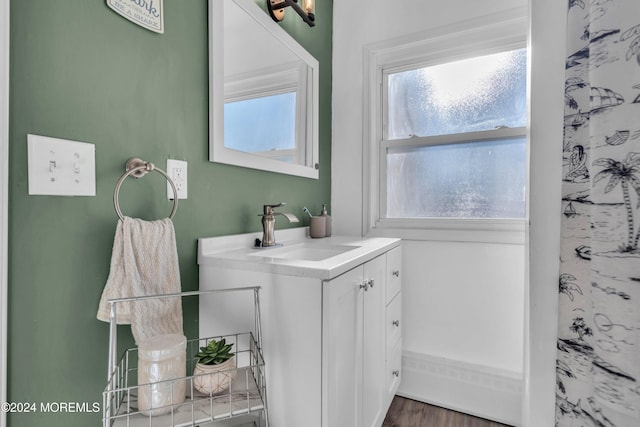 bathroom with vanity and hardwood / wood-style flooring