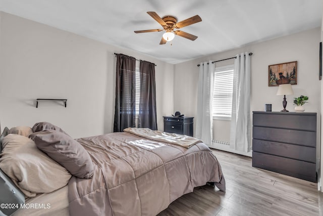 bedroom featuring light hardwood / wood-style flooring and ceiling fan