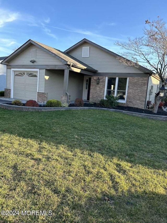 view of front facade featuring a garage and a front lawn