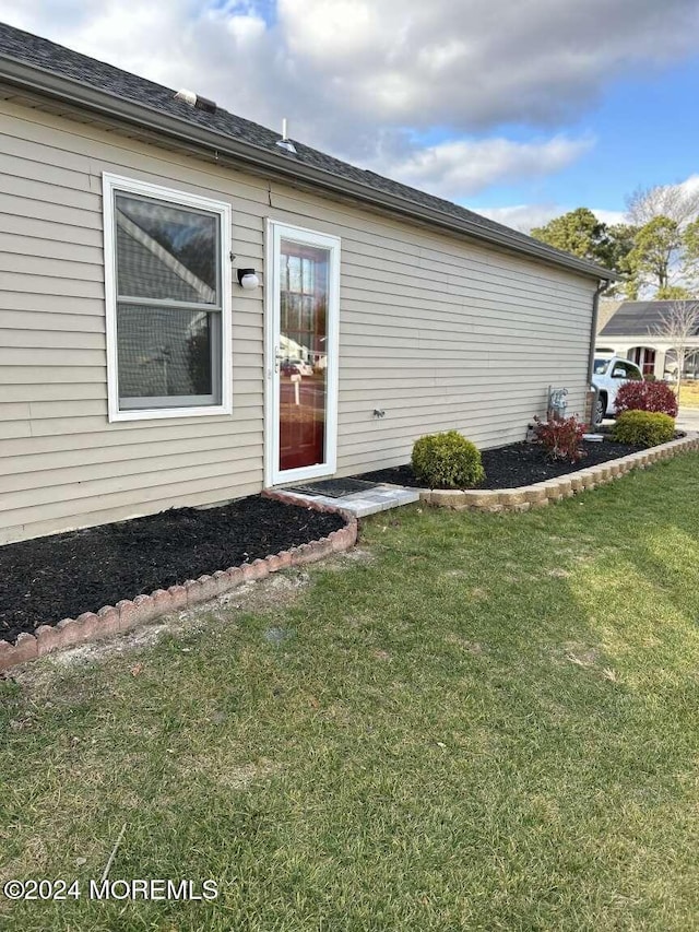 entrance to property featuring a yard