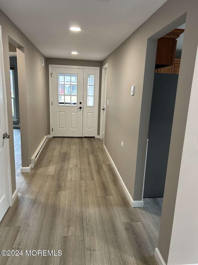 entryway with a baseboard radiator and light hardwood / wood-style flooring