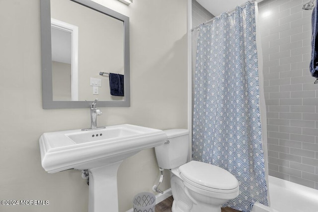 bathroom with curtained shower and toilet