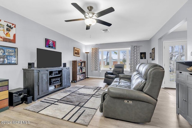 living room with ceiling fan and light hardwood / wood-style flooring