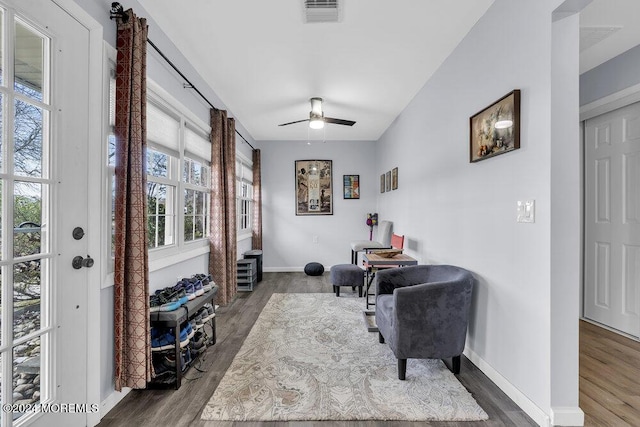 sitting room featuring dark hardwood / wood-style floors, ceiling fan, and a wealth of natural light