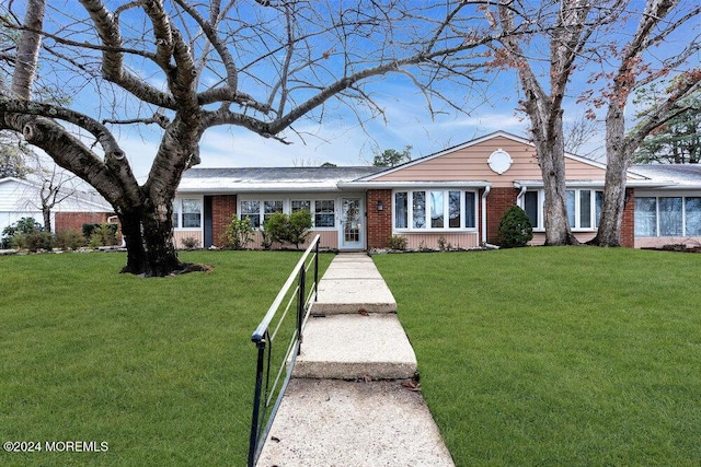 single story home featuring a front yard