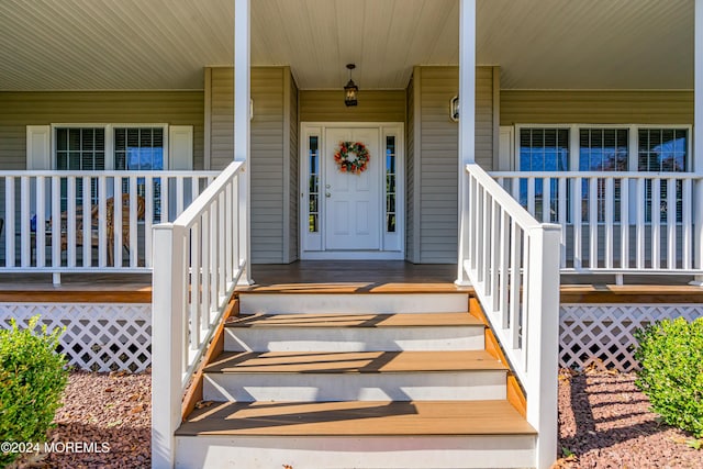 view of exterior entry with a porch